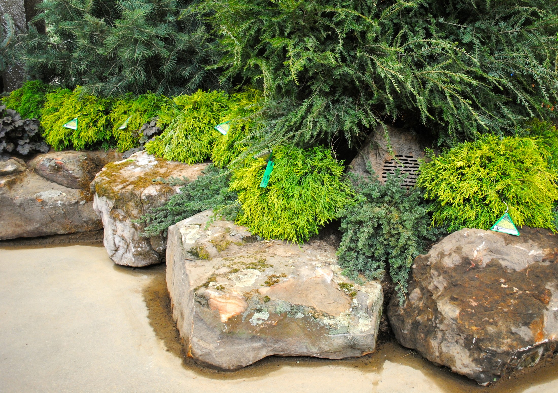 Outdoor audio system featuring rock-look landscape speakers and screens at the Indianapolis Flower & Patio Show by Noble A-V